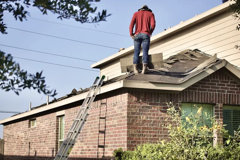 Professional roofer working on a residential roof in Coshocton